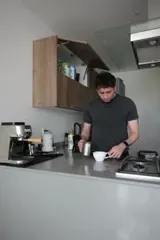 Last frame kept: a hand reaching for the coffee cup